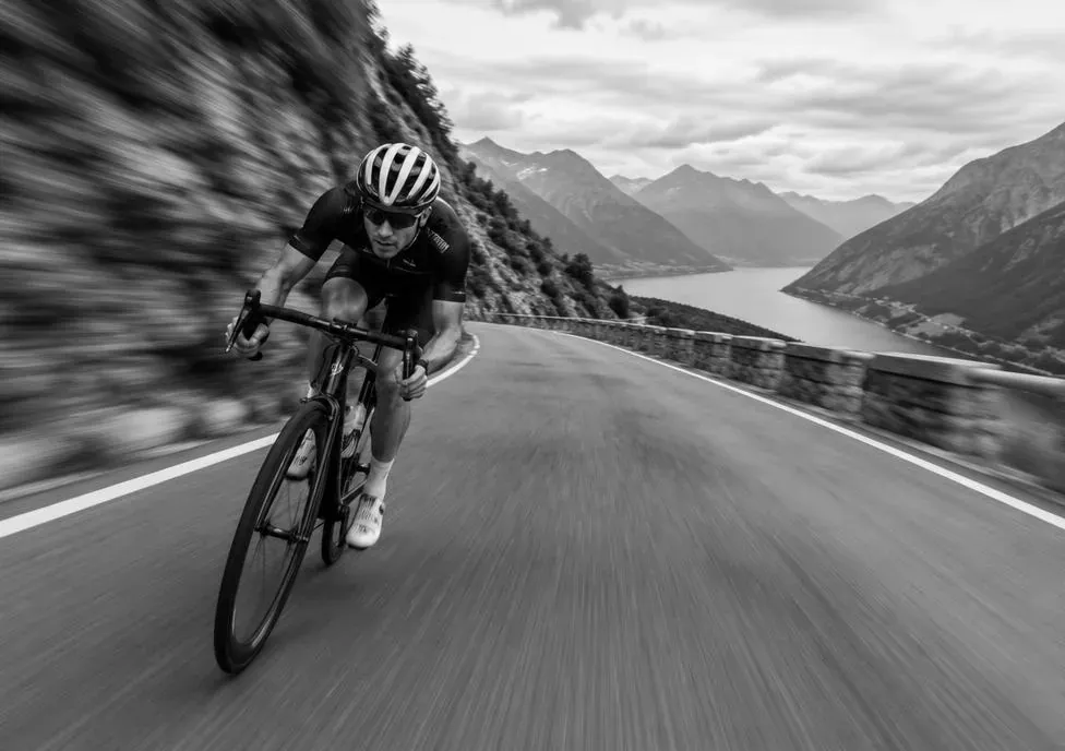 Cyclist descending a mountain road
